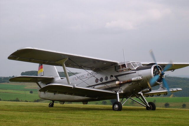 A commercial pilot in uniform, standing next to an aircraft, ready for flight.